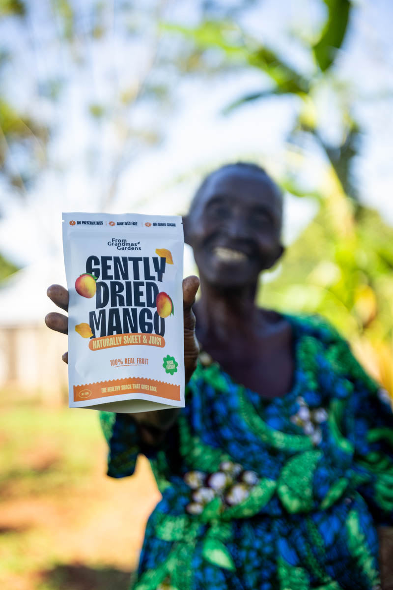 Grandmas holding up a packet of gently dried mango
